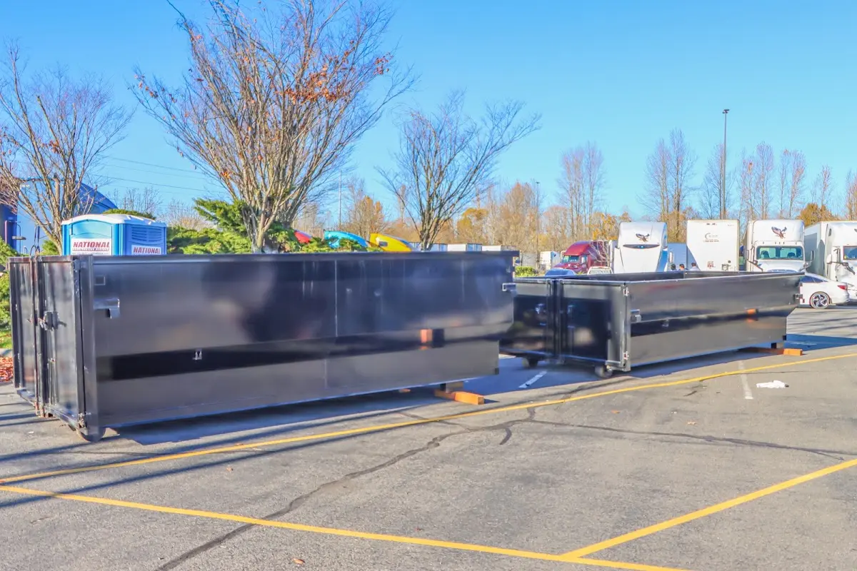 Professional dumpster rental service with roll-off container on residential driveway in Westchester